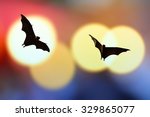 Bat silhouettes with colorful...