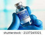 Small photo of Vaccination for booster shot for MMR Measless, Mumps and Rubella diseases in the children and adolescents. Doctor with vial of the doses vaccine for MMR Measless, Mumps and Rubella diseases
