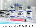 Small photo of Bottles of vaccine for Influenza Virus, Respiratory Syncytial virus and Covid-19 for vaccination. Flu, RSV and Sars-cov-2 Coronavirus vaccine vials in the medical clinic