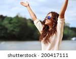 Happy smiling woman with hands raised - outdoor portrait 