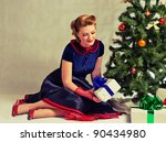 Woman Sitting Near A Christmas...