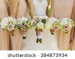 Bride and bridesmaids hand with beautiful flowers