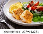 Small photo of Seared cod loin and fresh vegetables on wooden table