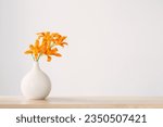 summer flowers in white modern vase on wooden shelf