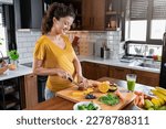 Small photo of Young beautiful pregnant lady making various fruit smoothies in the home kitchen. Fresh colorful healthy fruit juice. Healthy lifestyle in pregnancy. Smoothies for woman expecting baby.