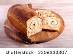 Cinnamon swirl bread, sliced on wooden board