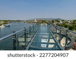 Skywalk Observation Deck made by transparent glass with beautiful Kanchanaburi city view by river in summer, Thailand.