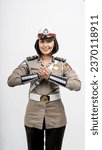 Small photo of jakarta, indonesia - september 12th 2023: a beautiful indonesian police woman in uniform doing hand gesture, in isolated white background