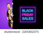 Small photo of Family portrait image - smiling father mother and little daughter peek out from behind big board isolated on violet purple background. Paper broadsheet with black friday sales text sign. Advertisement