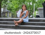 Small photo of A homeless, hungry, abandoned, runaway child looks for food and shelter in an outdoor environment