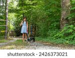 Small photo of A homeless, hungry, abandoned, runaway child looks for food and shelter with her little dog