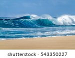 Big breaking Ocean wave on a sandy beach on the north shore of Oahu Hawaii