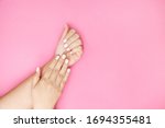 young female hands on a pink... | Shutterstock . vector #1694355481