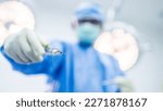 Small photo of Selective focus on surgical needle holder with blur background.Surgeon or doctor inside operating room did suture while surgery in hospital.Orthopedic or cosmetic and surgical emergency surgery.
