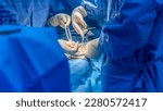 Small photo of Doctor or surgeon did surgery of hernia mesh repair operation inside operating room in hospital. Open repair of inguinal hernia in groin mass patient.Medical mesh device was use with blur background.