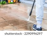 Small photo of Detail of cleaning terrace with high-pressure water blaster, cleaning dirty paving stones