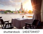 Small photo of Wat Arun temple, view point from the river side bar in Bangkok, Thailand, this image can use for Travel, restaurant and romantic concept