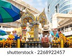 Small photo of Asian woman travel in erawan shrine Bangkok city, Thailand