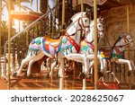 Close-up of merry go round carousel horses in sunset