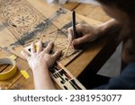 Small photo of Adult Caucasian Female Expertise Cutting a Wall Stencil Design in her Studio Workshop