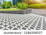 Environmentally friendly eco-paving - Concrete lawn grid with gravel filling for surface unsealing at residential house parking lot