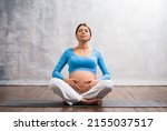 Young Pregnant Woman Doing Yoga ...
