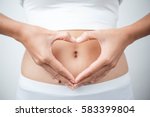 Close up of woman's hands made heart on belly isolated on white background.health care concept.