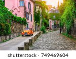 View of old street in quarter Montmartre in Paris, France. Cozy cityscape of Paris. Architecture and landmarks of Paris. 