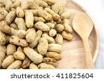 Closeup wooden dish of Peanut, Ground nut, Earth nut, Goober nut, Pindar nut, Monkey nut on white background; Top view of Peanut, Ground nut, Earth nut, Goober nut, Pindar nut, Monkey nut.