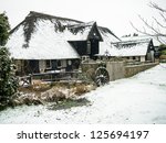 Thatched Building In The Snow