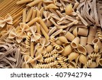 Variety of types and shapes of dry wholemeal pasta