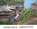 Small photo of SLUM OF NAIROBI, KENYA - NOVEMBER 18, 2022: Residents on the streets of the slums of Nairobi, Kenya. Largest urban slum in Africa