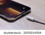 Small photo of BANGKOK,THAILAND-OCTOBER 9: View of Apple Iphone 13 Pro Max with Lighting Cable Charger on October 9,2021. EU try to Forced Apple Iphone to Use Usb-c Instead of Lighting Cable in the Nearly Future