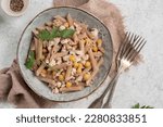Spelt penne pasta with chicken and chickpeas. Healthy lunch or dinner meal