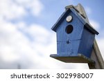 Blue Bird House In Front Of...