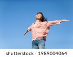 asian Young Woman Cheering Open Arms with isolated sky blue background