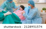 Small photo of asian pregnant woman in delivery room is preparing to give birth and husband is comforting her in hospital