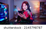 Small photo of cybersport gamer have live stream and say hello to her fans with the smartphone