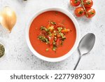 Small photo of Gazpacho soup in bowl over light stone background. Cold tomato soup. Top view, flat lay
