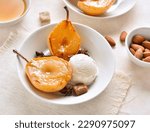 Small photo of Ice cream with poached pears in bowl over light background. Close up view