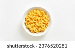 Small photo of Macaroni and cheese in bowl over white background with copy space. Top view, flat lay