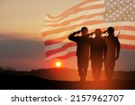Small photo of USA army soldiers saluting on a background of sunset or sunrise and USA flag. Greeting card for Veterans Day, Memorial Day, Independence Day. America celebration. 3D-rendering.