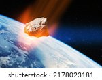 Planet Earth and big asteroid in the space. Potentially hazardous asteroids. Asteroid in outer space near Earth planet. Elements of this image furnished by NASA.