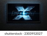 Small photo of TV screen playing Fast X also known as Fast and Furious 10 trailer or movie. TV on black textured wall. Astana, Kazakhstan - May 1, 2023.