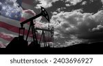 Small photo of The change in oil prices caused by the war. Oil price cap concept. Oil drilling derricks at desert oilfield with USA flag. Crude oil production from the ground. Petroleum production.