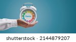 Small photo of Dietician holding a clock with vitamins, healthy diet and nutrition concept