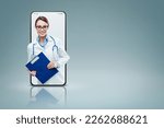 Professional woman doctor in a smartphone videocall and smiling, online doctor and telemedicine service concept