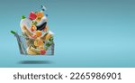 Small photo of Fresh groceries and goods falling in a supermarket trolley, grocery shopping concept