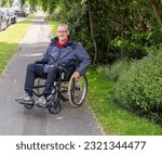 Small photo of Knutsford, Cheshire, UK. 2nd June 2023. Customer in self propelled wheelchair hired from the Red Cross Mobility Aids Service, Knutsford, Cheshire, UK