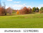 Autumn Park With Green Meadow.